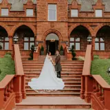 Couple posing on the stairs in front of Boclair House Hotel
