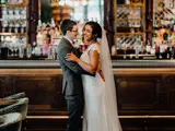 married couple on wedding day inside ornate bar at boclair house