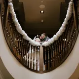 Couple kissing in the stairwell at Boclair House