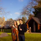 Couple standing in front of the lodges 