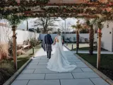 Married couple walking in the garden of The Garden House at The Redhurst Hotel Glasgow