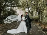 Couple standing in road in front of castle