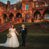 Same sex couple posing outside of Boclair House Hotel