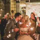 Couple kissing under sparklers