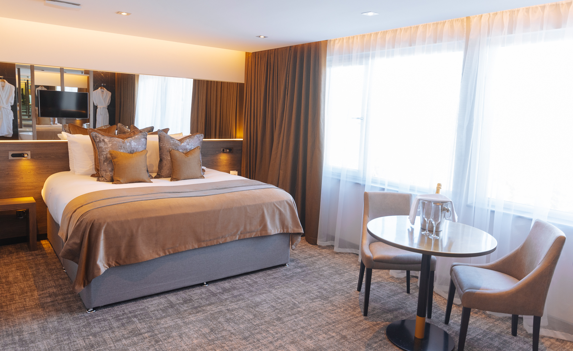 Bedroom with bed and tables and chairs