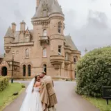 Couple posing in front of the castle