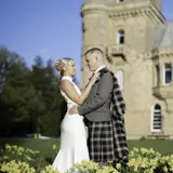 Couple just married in front of a wedding car