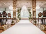 Interior view of the New Grand Ballroom at Boclair House, Glasgow, featuring luxury wedding decor, mirrored pillars, and a sparkling crystal chandelier