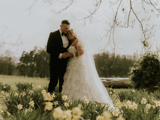 Couple sharing a moment in field after wedding