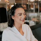 Bride smiling after having make up done 
