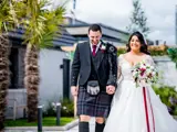 Happy couple at a Redhurst Hotel wedding in Giffnock, Glasgow, featuring traditional Scottish kilt attire.