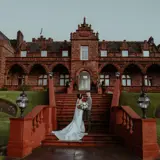 Couple sharing a moment on the stairs outside of Boclair House Hotel