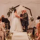 Couple holding hands at the alter
