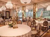 The Grand Ballroom at Boclair House Hotel set for a wedding meal, featuring rows of formal dining tables and opulent overhead chandelier lighting in a luxury Glasgow setting.