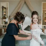 Bride and Bridesmaid getting ready in the honeymoon suite of Conrhill castle