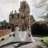 Same sex couple holding hands outside Cornhill Castle