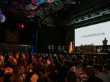 Manorview logo on screen while MV team playing bingo