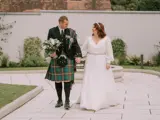 Bride and groom walking through the landscape gardens at Redhurst Hotel, Glasgow