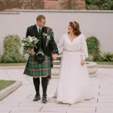 Couple walking infront of fountain
