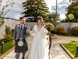 Newlyweds in the private landscaped gardens at The Redhurst Hotel with fountain feature