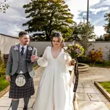 Newlyweds in the private landscaped gardens at The Redhurst Hotel with fountain feature