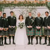 Couple standing with all Groomsmen