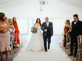 Father and bride walking down the aisle