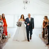 Father and bride walking down the aisle