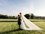 Couple walking on the grounds with sun setting on the background
