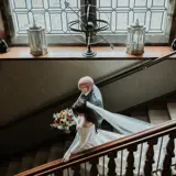 Bride and father walking down stairs in Cornhill Castle