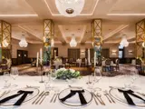 Wedding ceremony space at Boclair House Hotel, showcasing the New Ballroom's grand architecture, ornate gold ceiling, and white floral aisle decor for a luxury Glasgow wedding.