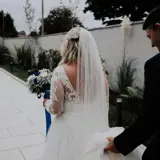 Shot of bride from behind showing dress and vail