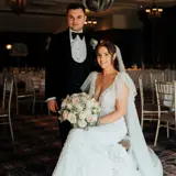 Couple posing in dining room after their ceremony