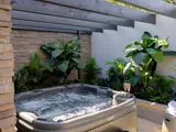 Outdoor hot tub setup at The Garden House Honeymoon Suite at Redhurst Hotel Glasgow
