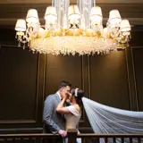 Couple kissing in the stairwell of Boclair House