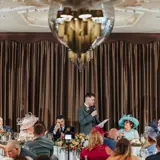 Groom giving his wedding suite