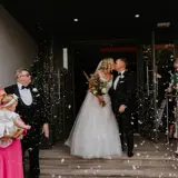 Couple kissing at the front door of Redhurst