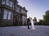 Couple kissing outside of Lynnhurst at sunset
