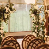 Floral displays and chairs set up in a function room in Boclair House in Glasgow