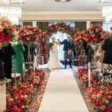 Wedding ceremony with colourful flowers in the Grand Ballroom at The Redhurst Hotel Glasgow