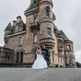 Couple standing in front of castle