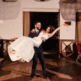 Groom holding bride after ceremony