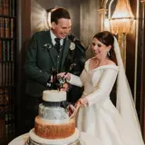 Couple cutting cake