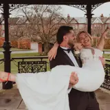Groom holding bride at the Band Stand