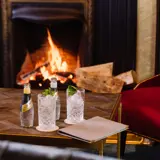 Drinks in front of a Fireplace