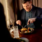 Man eating dinner at Cornhill Castle