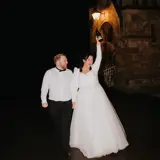 Couple sharing a bottle of champagne outside of the castle
