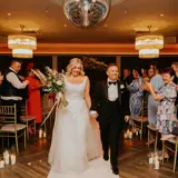 Couple walking down the aisle after being married
