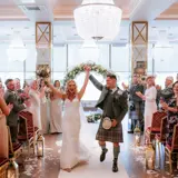 married couple celebrating walking down the aisle at boclair