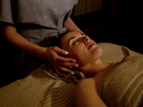 Relaxing spa treatment at Bowfield Hotel & Spa, a spa hotel near Glasgow, with a spa therapist giving a calming head and neck massage.